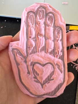 carved stamp of a hand