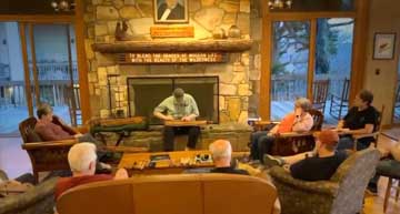 people listening to a person playing the dulcimer in a mountain lounge