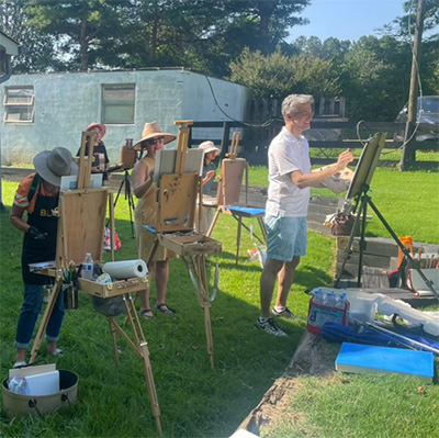 painting instructor teaches plein air painting for his students