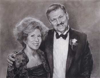 portrait of a middle-aged man and woman smiling arm-in-arm at a dressy occasion in the late 1990s or early 2000s