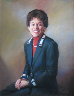 pastel portrait of a seated smiling brunette woman wearing a red turtle neck and a navy blue jacket