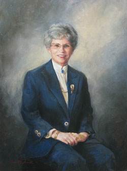oil portrait painting of a woman with gray hair wearing a white blouse and a navy blue jacket and jewelry